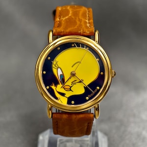 Reloj vintage de cuarzo Tweety Armitron con esfera azul y correa de piel en tono dorado, año 1994