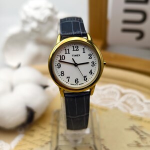 Vintage 1990s Timex Ladies Quartz Gold Tone Watch 30mm White Dial Indiglo Blue Strap