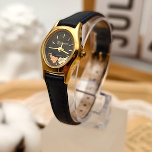 Orologio da donna al quarzo Rushmore vintage anni '90 con quadrante nero color oro e motivo a foglia