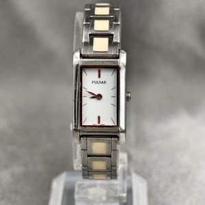 Vintage pulsar by seiko ladies silver tone quartz tank watch with white accents