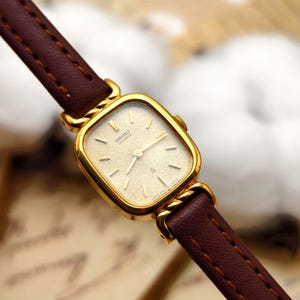 Vintage 1990s Seiko Ladies Gold Plated Quartz Watch Rectangular Case Textured Dial Brown Leather
