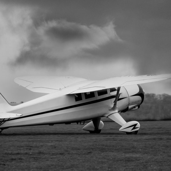 Monochrome image of a vintage single engined monoplane aircraft. Classic style.