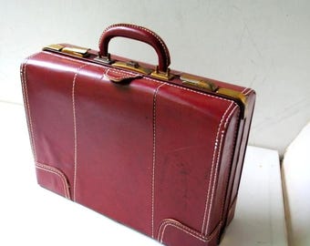 1950  mahogany  brown leather  sturdy , wide, small  suitcase  with  gold tome metal  hard wear ,  white  thick   threads stitching.