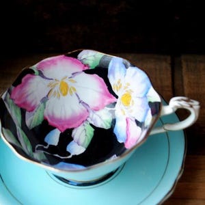1950 vintage ,  fine  porcelain, famous , teal blue tea set , black interior, large purple / pink orchid  on it, by purple double Paragon.