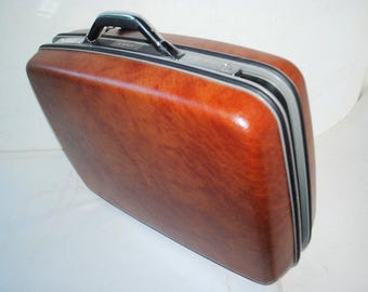 1982  vintage,  brown  hard shell , handsome  suitcase/ luggage  " Samsonite  Survivor "with an original key and  booklet.