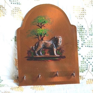 1987  vintage, unique  wall plague - key  holder / rack , cooper on wood ,  raised   figure of lion,  hand painted a savanna  scene.