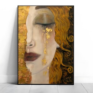 Peut inclure: Peinture artistique d'un visage de femme de profil, les yeux fermés et des larmes d'or. L'œuvre utilise une palette de couleurs or, marron et crème, avec des coups de pinceau texturés et un cadre noir. Les cheveux de la femme sont dorés et ondulés.