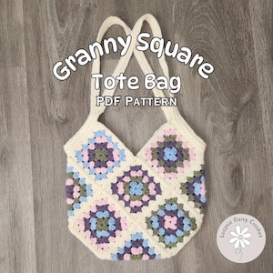 May include: A white crochet tote bag with a granny square pattern in shades of pink, blue, green, and purple. The bag has a crossed strap design and the text "Granny Square Tote Bag PDF Pattern" is written on the bag.
