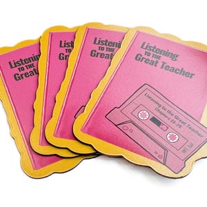 May include: Four pink and gold coasters with the text "Listening to the Great Teacher" and a cassette tape graphic. The text "Listening to the Great Teacher" is repeated on each coaster.
