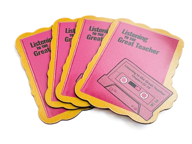 May include: Four pink and gold coasters with the text "Listening to the Great Teacher" and a cassette tape graphic. The text "Listening to the Great Teacher" is repeated on each coaster.