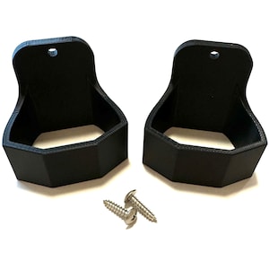 May include: Two black plastic wall mounts with a hexagonal shape and a small hole at the top. The mounts are designed to hold objects like a broom or mop. Two silver screws are included.