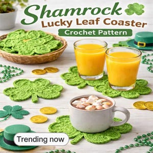 May include: Green crochet shamrock leaf coasters with a basket of coasters, two glasses of orange juice, and a mug of hot chocolate. The image includes gold coins, green beads, and a green hat. Text reads "Shamrock Lucky Leaf Coaster Crochet Pattern."