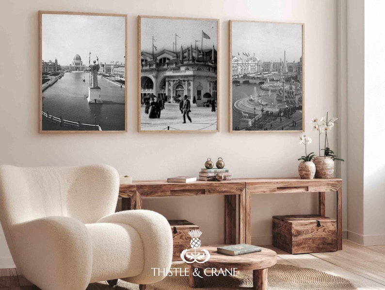 May include: Three framed black and white wall art prints depicting historical architectural scenes with water, statues, and people in period clothing. The prints are displayed in light wood frames and hung in a horizontal row on a plain wall.