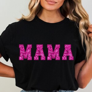 May include: Black t-shirt with the word "MAMA" in pink glitter lettering.
