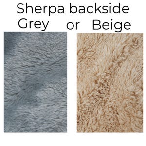 May include: The image displays two samples of Sherpa fabric. One is a soft, textured grey, and the other is a warm beige. The text at the top reads "Sherpa backside Grey or Beige."