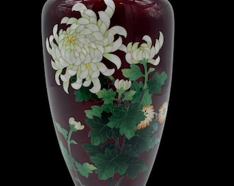 May include: A dark red vase with a silver rim, decorated with white and yellow chrysanthemums and green leaves.
