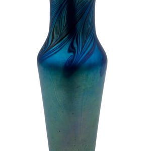 May include: A blue iridescent glass vase with a swirling pattern. The vase has a narrow neck and a wide base.