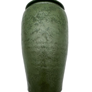 May include: A cylindrical ceramic vase with a rounded top rim, featuring a deep forest green glaze with a mottled, textured finish that creates a subtle crackled appearance across the entire surface of the vessel, standing upright against a white background.