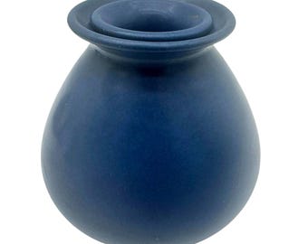 May include: A matte navy blue ceramic vase with a rounded, bulbous body and a wide, flared rim. The vessel features a smooth, solid-colored surface with a consistent dark blue finish throughout its exterior, showcasing a simple, functional form.