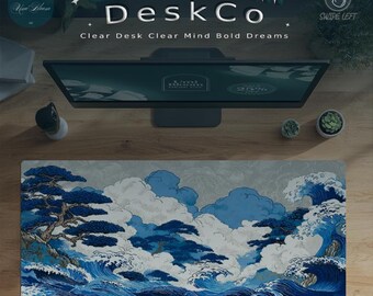 May include: A desk setup with a monitor, small potted plants, and a decorative desk mat. The mat features a Japanese-style wave and cloud design in blue and white, with the text "UmiBloom Desk Co."
