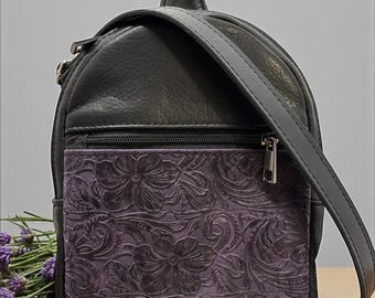 Bolso bandolera de cuero con acceso rápido y tirador para transporte oculto.