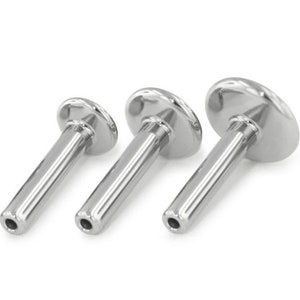 May include: Three silver surgical steel body jewellery pieces, each with a flat, round top and a cylindrical post. The pieces are arranged in order of size, with the smallest on the left and the largest on the right.