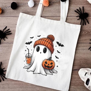 a white bag with a ghost holding a pumpkin