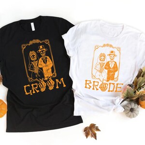 a couple of t - shirts sitting on top of a table