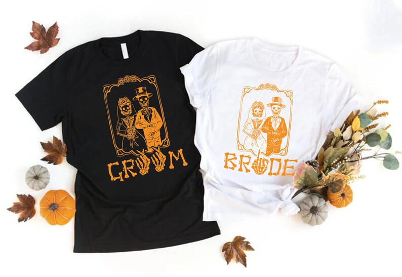 a couple of t - shirts sitting on top of a table