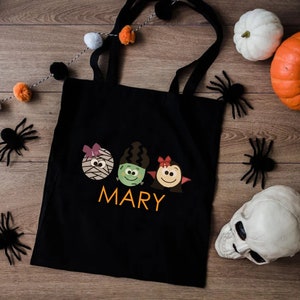 a trick or treat bag sitting on top of a wooden floor