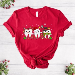 a red t - shirt with a tooth design on it