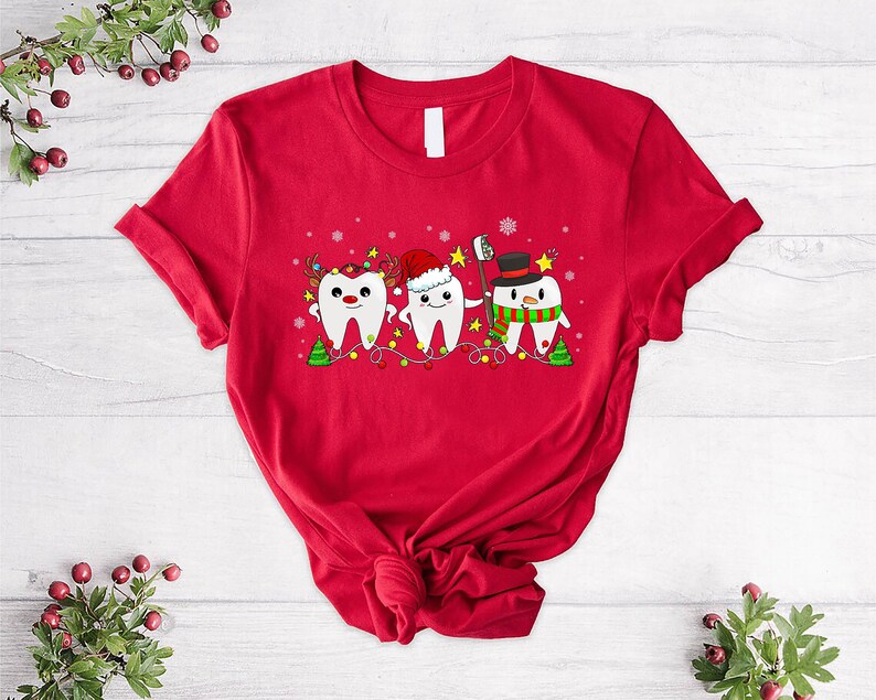 a red t - shirt with a tooth design on it