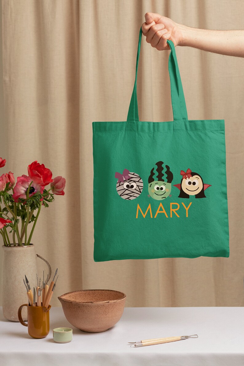 a person holding a green bag with two birds on it