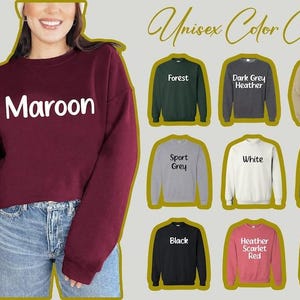 a woman wearing a maroon and black sweatshirt with the word maroon on it