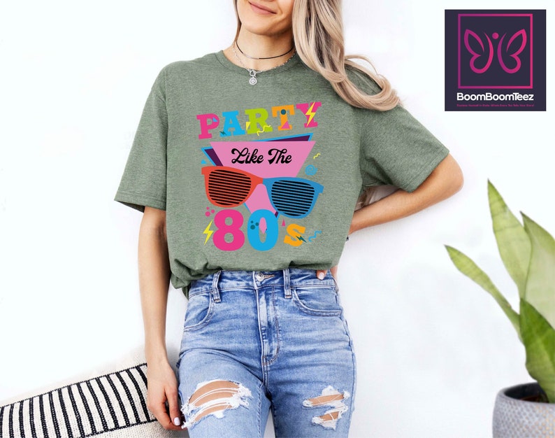 May include: Green t-shirt with a graphic of sunglasses and the text "Party Like The 80's".