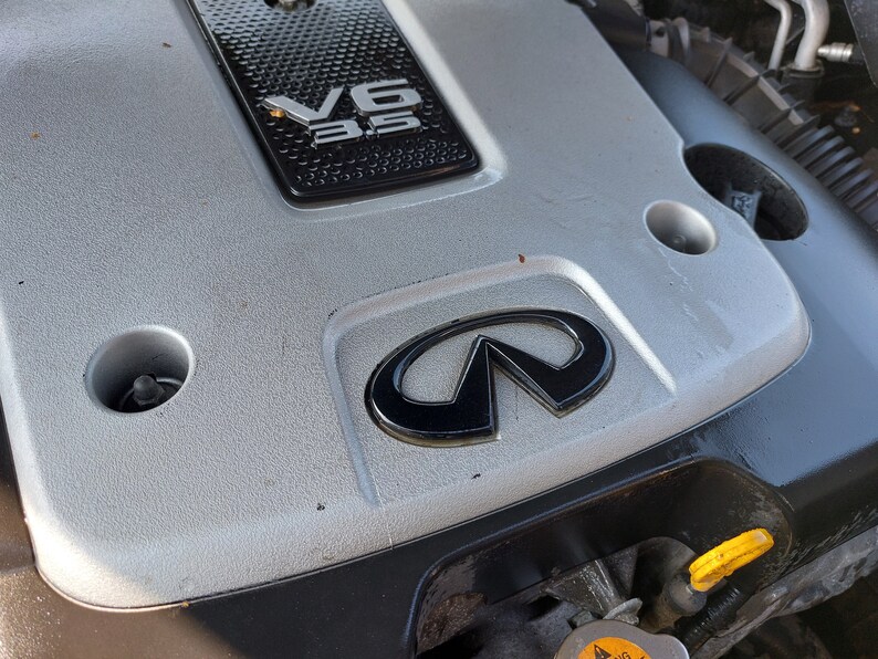 Glossy Black Infiniti Engine Cover Emblem Badge – Adhesive Mount For G35, G37, FX35, M37, EX35, QX50 & More