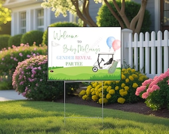 May include: A yard sign for a baby gender reveal party. The sign reads "Welcome to Baby McCarry's Gender Reveal Par Tee" with a golf cart, balloons, and golf course elements. The sign is set in a well-manicured lawn.