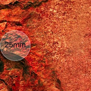 May include: Close-up of a red and orange textured surface with a circle showing a 25mm measurement.
