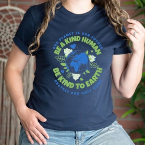 May include: A navy blue t-shirt with a green and blue graphic of the Earth. The graphic includes the text "Our planet is our future, Be a kind human, Be kind to Earth, Protect our only home".