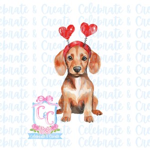 Puede incluir: Una ilustración de acuarela de un dachshund marrón y tostado con una diadema de corazón rojo. El perro está sentado sobre un fondo blanco con el texto "Celebrate & Create" en azul.