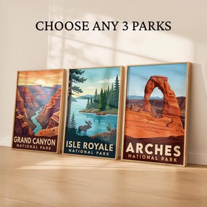 May include: Three framed art prints featuring national park landscapes. The prints showcase Grand Canyon, Isle Royale, and Arches National Park. Each print has a wooden frame and includes the park name. The text "CHOOSE ANY 3 PARKS" is at the top.