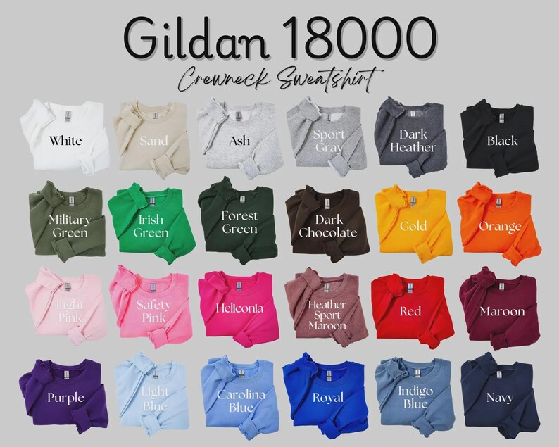 May include: A Gildan 18000 crewneck sweatshirt colour chart featuring twenty-four folded garments in various shades including white, sand, ash, sport grey, dark heather, black, military green, irish green, forest green, dark chocolate, gold, orange, light pink, safety pink, heliconia, heather sport maroon, red, maroon, purple, light blue, carolina blue, royal, indigo blue, and navy.
