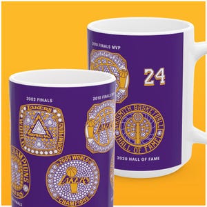 May include: Purple ceramic mug with a design of basketball championship rings and the text "2010 Finals MVP", "2002 Finals", "2009 World Champions", "2020 Hall of Fame", "Smith Basketball Hall of Fame", and "24".