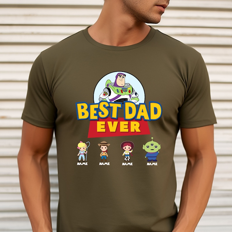May include: Olive green t-shirt featuring a graphic of Buzz Lightyear and the text "BEST DAD EVER." Below the text are cartoon characters with the word "NAME" under each. The shirt is made of a soft material.