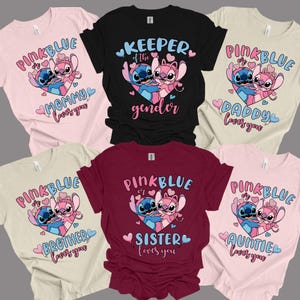 May include: Assorted t-shirts featuring a cartoon couple in a heart, with text like "Mommy loves you," "Daddy loves you," and "Keeper of the gender." The shirts are in various colors, including pink, black, and burgundy.