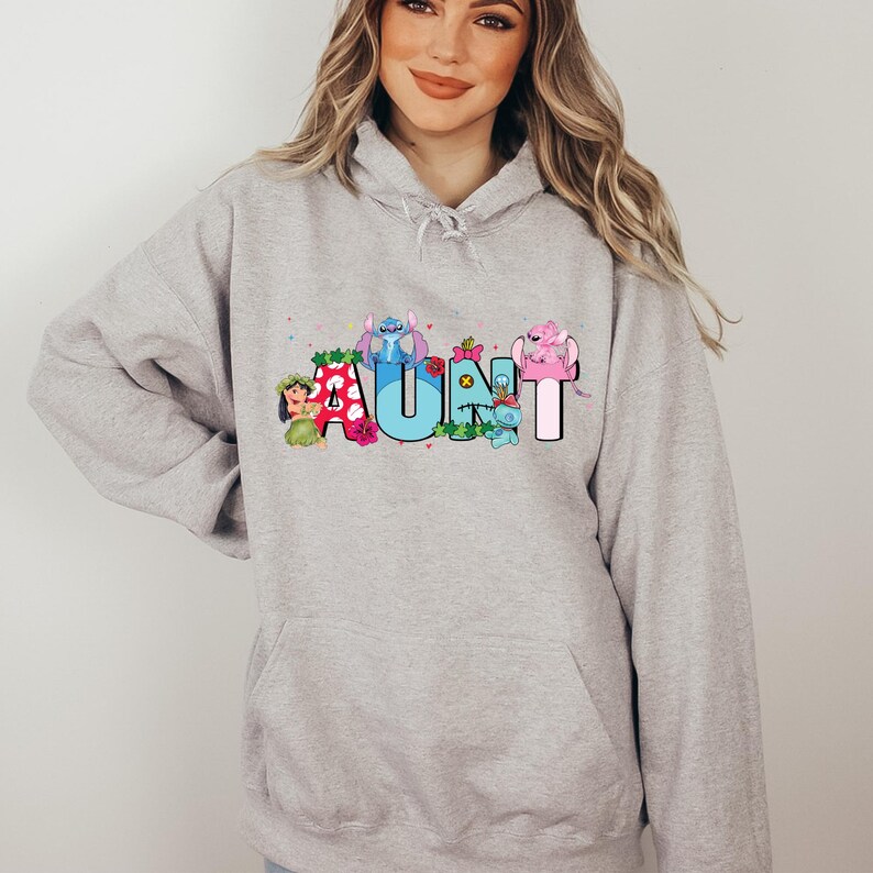 May include: Gray hooded sweatshirt with a graphic print of the word "AUNT" spelled out with cartoon characters. The characters are from the Disney movie Lilo & Stitch.