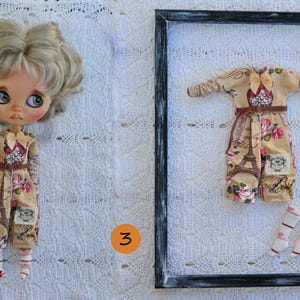 Puede incluir: Una mu&ntilde;eca de cabello rubio ondulado y ojos grandes viste un mono beige con estampado floral y de la Torre Eiffel, junto a un mono y calcetines a juego dentro de un marco rectangular negro, marcado con el n&uacute;mero 3 en un c&iacute;rculo naranja.