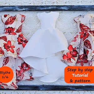 May include: Three doll dresses displayed in a rectangular frame. Two dresses feature a cream fabric with a red floral and butterfly print. One central dress is solid white. Orange labels read Blythe 1/6 and Step by step Tutorial & pattern.