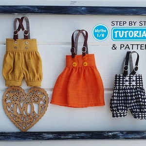 May include: Three different doll outfits for a Blythe doll, including a pair of mustard yellow dungarees, a bright orange dress with straps, and a black and white checked pair of dungarees. The outfits are hanging on a white background with a wooden heart cutout in the center. The text "blythe 1/6" and "STEP BY STEP TUTORIAL & PATTERN" is visible in the image.