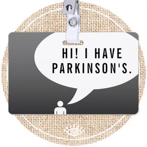 May include: A black and white name tag with a speech bubble that says "Hi! I have Parkinson's."